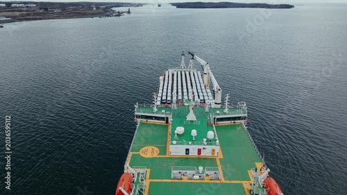 aerial view, drone, The transport ship is at Halifax port in Nova Scotia. It is loaded with cars ready for export. The cargo ship prepares to leave the port for delivery to other locations