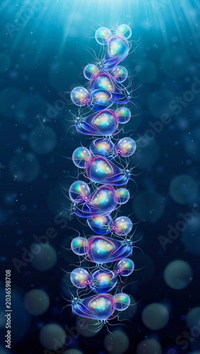 An abstract, illuminated vertical structure resembling a DNA strand composed of glowing, bubble-like microscopic organisms in deep blue water.