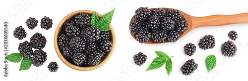 blackberry in wooden bowl and spoon with leaf isolated on a white background closeup
