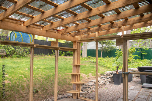nterior view of a wooden outdoor catio enclosure with wire mesh
