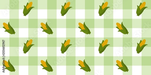 ​Seamless corn pattern on green gingham background.
