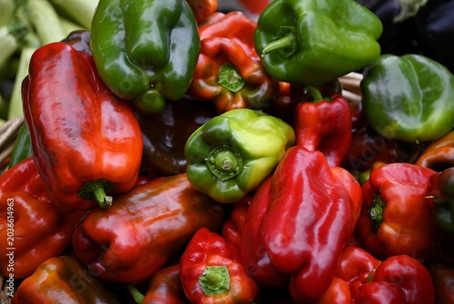Obraz na płótnie Fresh organic elongated green and red bell peppers on display at a local farmer's market in Catania Sicily, Italy