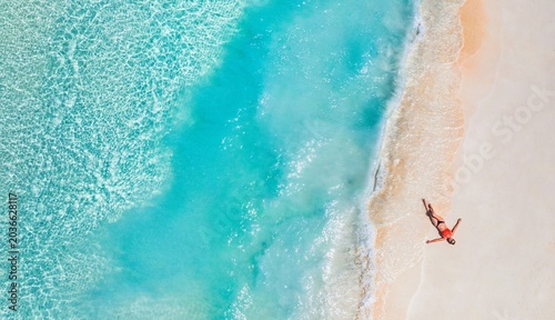 Canvastavla Aerial top view woman relax sunbathing soft sandy shore tropical beach turquoise