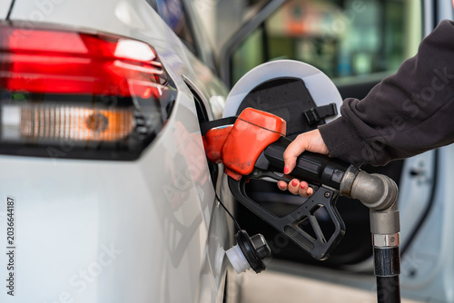 Close up hand gas station attendant refueled car with petrol, Concept travel and transportation.