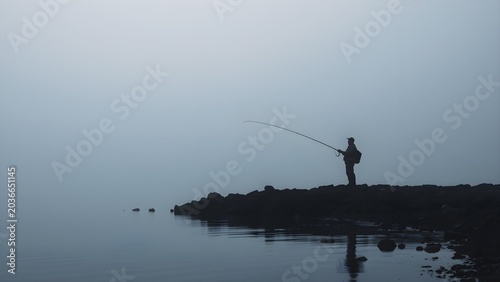 Fisherman Silhouette Casting Line Misty Lake Dawn Distant Small Figure