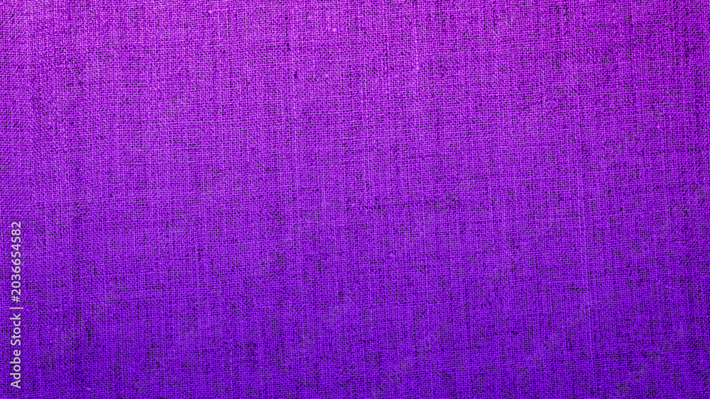 Fototapeta premium Purple fabric texture shows fine details and a rich color, ideal for backgrounds and design projects on a sunny day