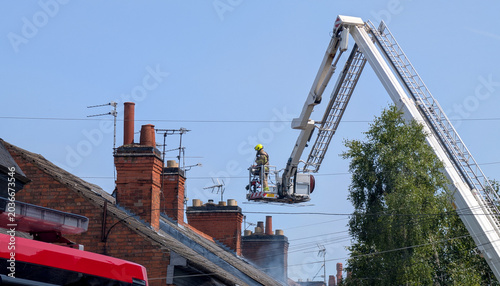 Canvas-taulu Firefighter in cherry picker platform, crane bucket, hydraulic platform lifting