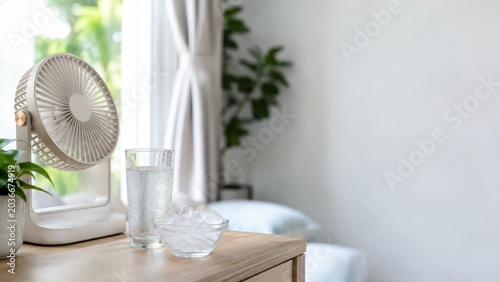 Portable fan with ice water in bright room for summer heat relief and cooling