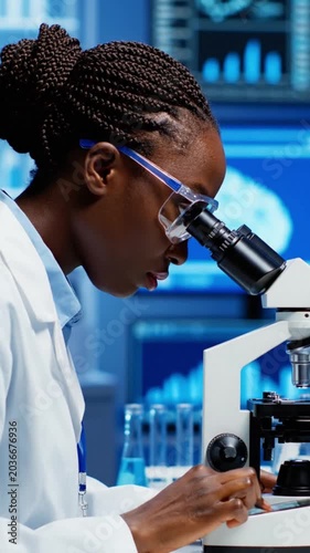 Woman Using Microscope in Laboratory Setting.