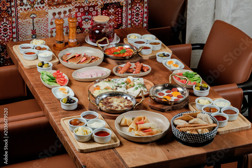 Traditional Azerbaijani breakfast table for four person. Traditional carpet on background