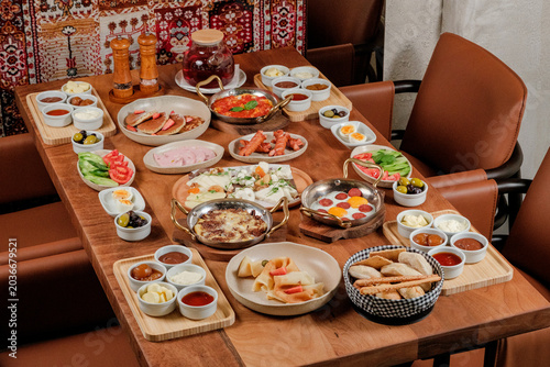 Traditional Azerbaijani breakfast table for four person. Traditional carpet on background