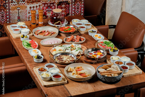 Traditional Azerbaijani breakfast table for four person. Traditional carpet on background