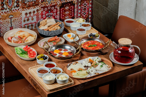 Traditional Azerbaijani breakfast table for two person. Traditional carpet on background