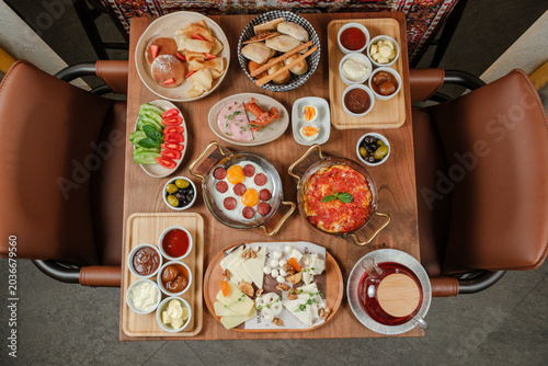 Traditional Azerbaijani breakfast table for two person top view. Traditional carpet on background