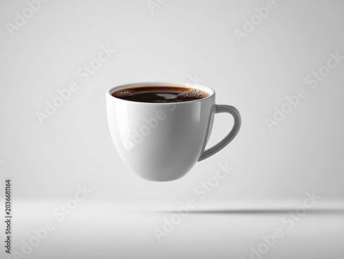 White ceramic coffee cup filled with black coffee on gray background