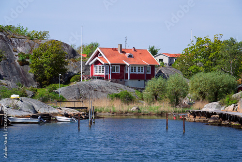Beautiful holiday cottages on shore of Gothenburg archipelago islands, Gothenburg Minucipality, Vastra Gotaland County, Sweden, sunny day