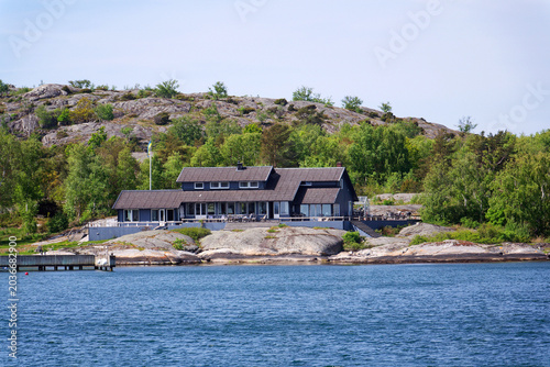 Beautiful holiday cottages on shore of Gothenburg archipelago islands, Gothenburg Minucipality, Vastra Gotaland County, Sweden, sunny day
