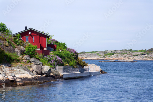 Beautiful holiday cottages on shore of Gothenburg archipelago islands, Gothenburg Minucipality, Vastra Gotaland County, Sweden, sunny day
