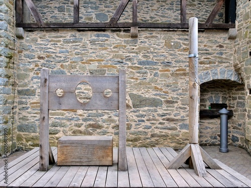 Fotografie A wide shot displays authentic replicas of medieval punishment devices
arranged on a wooden platform