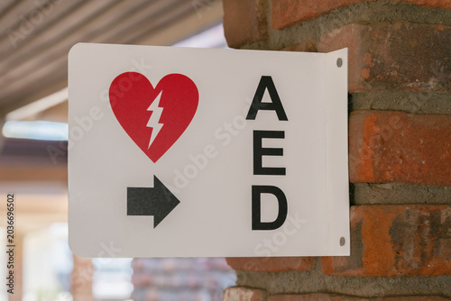 AED Emergency Defibrillator Location Sign Mounted On Brick Column