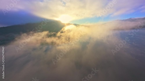 FPV Drone Soaring Towards Golden Sun Over Lake Mist