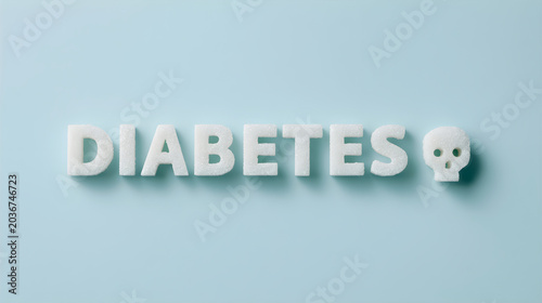 Word diabetes spelled with sugar cubes and a skull shape on blue background. Concept of unhealthy diet, sugar addiction, metabolism disorder, and chronic disease and glucose awareness.