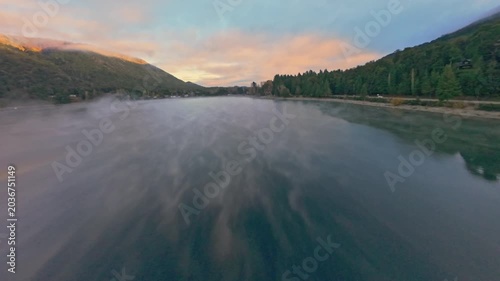 Calm Lake Reflection at Dawn Aerial FPV Shot