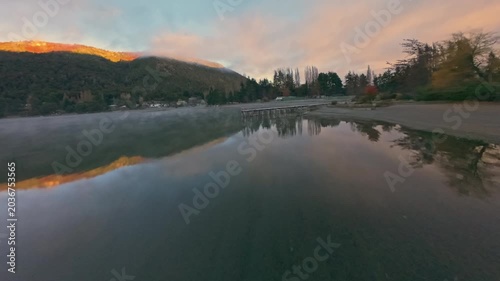 Peaceful Dawn Glide Over Foggy Mountain Lake