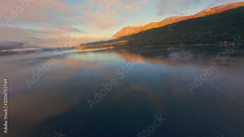Misty Lake Surface Aerial Tracking Shot at Sunrise