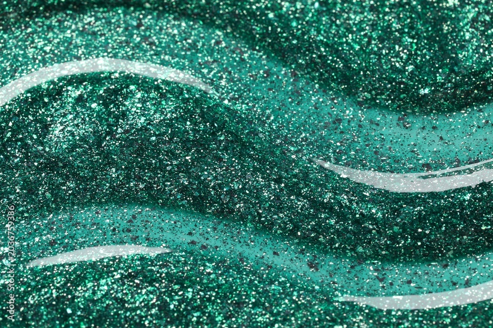 Fototapeta premium Green glitter nail polish as background, top view