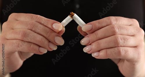 Quadro su tela Woman breaking cigarette, closeup. Quitting bad habit