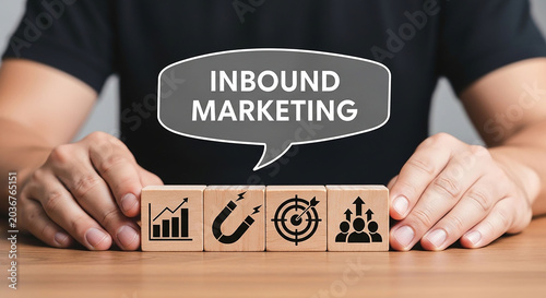 Inbound Marketing Strategy: A person is displaying wooden cubes with symbols representing business growth, attraction, target, and teamwork, all under the umbrella of Inbound Marketing.