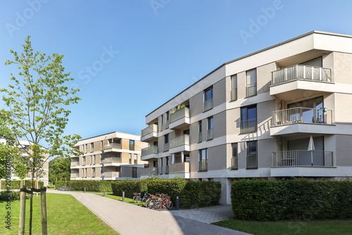 Cityscape of a residential area with modern apartment buildings, new sustainable development and green urban landscape in the city, concept for construction industry and real estate