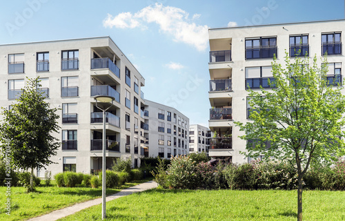Cityscape of a residential area with modern apartment buildings, new sustainable development and green urban landscape in the city, concept for construction industry and real estate