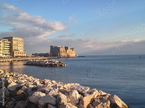 Seafront in Naples, Italy. Ovo Castle under blue sky
