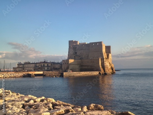 Seafront in Naples, Italy. Ovo Castle under blue sky