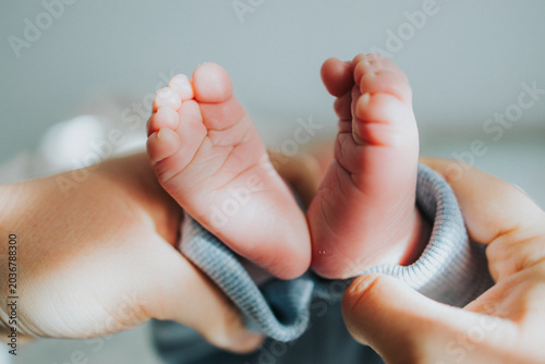 person holding baby feet 