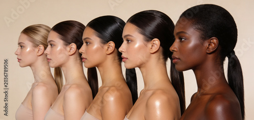 Diverse group of women with different skin tones lined up showing facial profile. Beauty concept of inclusivity and skincare. Healthy glowing skin of female models for cosmetic advertisement.