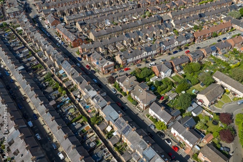 Detailed aerial drone view of terraced housing and suburban streets in the city of York North Yorkshire England showing brick homes gardens roads and residential urban development I n the summer