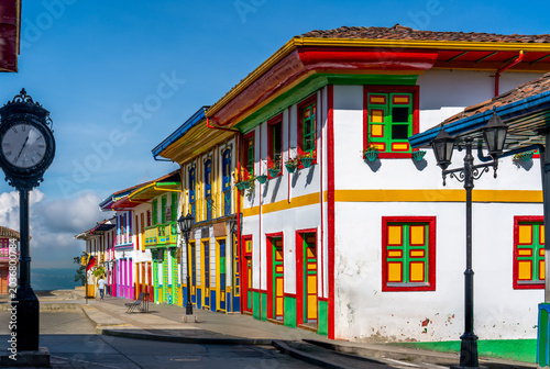 Colombia, Salento,a picturesque street corner features colorful painted houses and a street clock.
