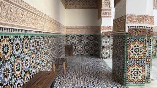 Ornate Islamic courtyard doorway with mosaic tiles at Ben Youssef Madrasa Marrakech