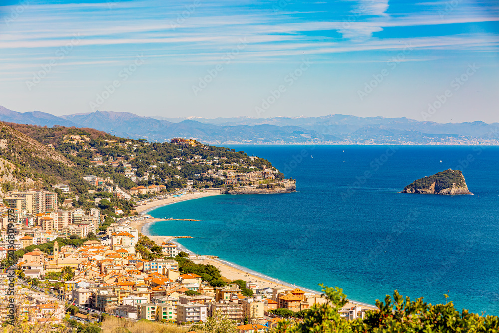 Fototapeta premium Aerial panoramic view of the coast of Spotorno, Bergeggi Island, Torre del Mare, Liguria, province of Savona, Italy. Riviera dei Fiori. Western Riviera. Ligurian Sea