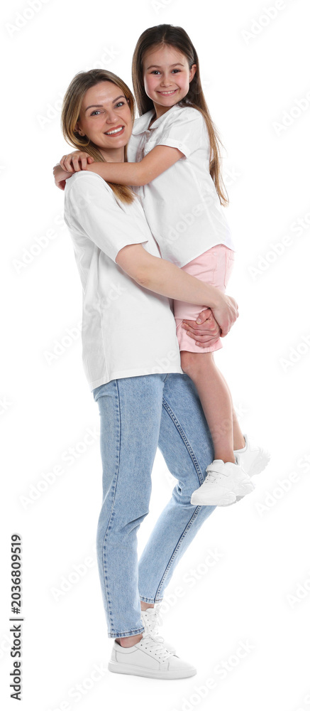 Fototapeta premium Happy mother and her daughter posing on white background. Friendly family