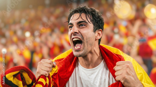 Passionate fan wears Spain's red and yellow flag