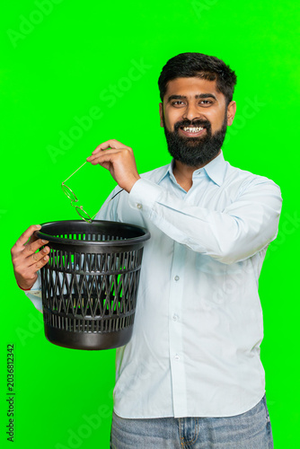 Indian man smiles, removes eyeglasses and tosses them away with satisfaction, symbolizing freedom after vision correction. Arabian guy isolated on chroma key background showing treatment eye recovery
