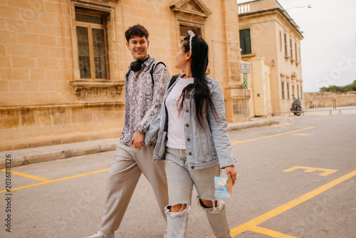 Happy couple enjoying in walk and talk on the street