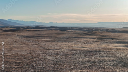 The road through a barren and arid  stunning  landscape to the mountains around Lake Oahu with snow on the peaks reflected on the village side of the Lake. One of my favourite lakes in NZ and the scen