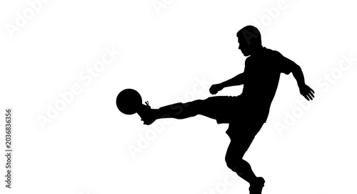 Bild auf Leinwand Soccer Player Silhouette Kicking Ball