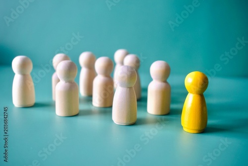 Foto Yellow Wooden Figure Standing Completely Separated on Right Side