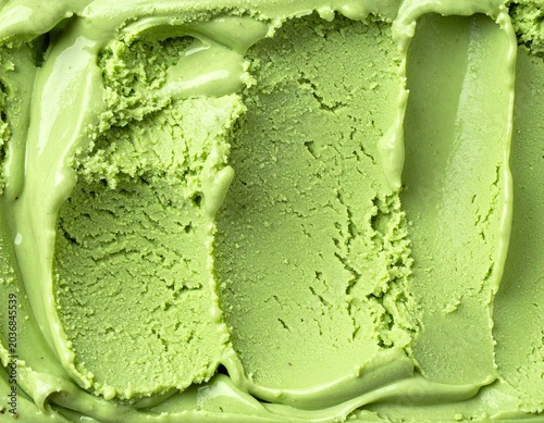 Close-up top view of matcha green tea ice cream texture with textured scoop marks